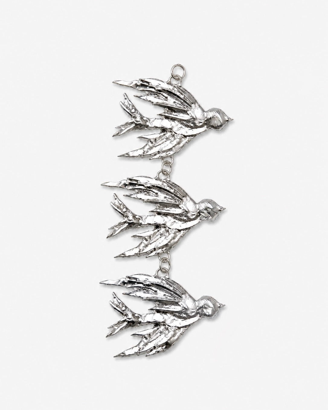 Silver bird-shaped pendant on a white background